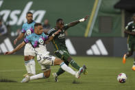 Portland Timbers forward Franck Boli fights for the ball against Minnesota United during an MLS soccer match at Providence Park in Portland, Ore. on Saturday, May 20, 2023. (Vickie Connor/The Oregonian via AP)