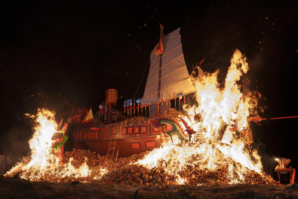A Wangkang ship is set aflame during the night culminating ceremony so that the collected spirits can symbolically sail into another realm during Wangkang or "royal ship" festival in Malacca, Malaysia, Thursday, Jan. 11, 2024. The Wangkang festival was brought to Malacca by Hokkien traders from China and first took place in 1854. Processions have been held in 1919, 1933, 2001, 2012 and 2021. (AP Photo/Vincent Thian)