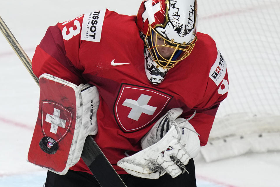 Switzerland's goalkeeper Leonardo Genoni makes a save during the preliminary round match between Switzerland and Norway at the Ice Hockey World Championships in Prague, Czech Republic, Friday, May 10, 2024. (AP Photo/Petr David Josek)
