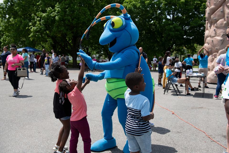 Children interact with Spark the Firefly in South Bend. South Bend Venues Parks & Arts (VPA) presents Kids to Parks Day May 20, 2023, at Potawatomi Park.