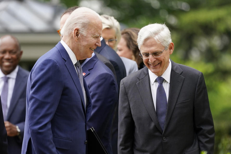 President Joe Biden walks back to the Oval Office past Attorney General Merrick Garland after speaking in the Rose Garden of the White House in Washington, Friday, May 13, 2022, during an event to highlight state and local leaders who are investing American Rescue Plan funding. (AP Photo/Andrew Harnik)