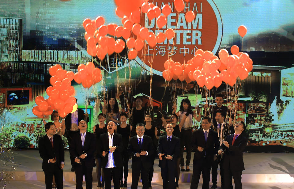 Jeffrey Katzenberg, CEO of DreamWorks Animation, third from right, Li Ruigang, Chairman & CEO of China Media Capital, fourth from right, and Allan Zeman, Chairman of Lan Kwai Fong Group, third from left, together with representatives from the Shanghai government, unveil the master plan for the Shanghai DreamCenter on Thursday March 20, 2014 in Shanghai, China. DreamWorks Animation and Chinese partners unveiled designs on Thursday for a 15 billion yuan ($2.4 billion) entertainment complex in Shanghai, expanding Hollywood’s growing ties with China. (AP Photo)