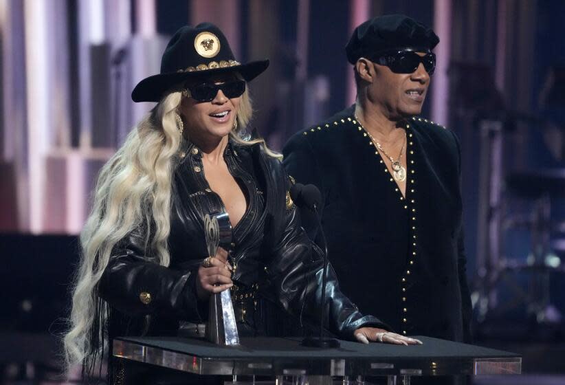 Beyonce and Stevie Wonder appear onstage together to accept an award