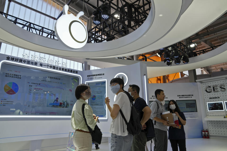 Visitors tour the Ant Group booth during the China International Fair for Trade in Services (CIFTIS) at the Shougang venue in Beijing on Sept. 1, 2022. Chinese e-commerce giant Alibaba says it does not plan to sell any shares in its one-third shareholding in financial technology company Ant Group because it wants to retain its stake in an "important strategic partner." (AP Photo/Andy Wong)