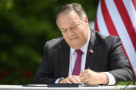 US Secretary of State Mike Pompeo signs an agreement on fifth-generation internet technology with Slovenia's Foreign Minister Anze Logar in Bled, Slovenia, Thursday, Aug. 13, 2020. Pompeo is on a five-day visit to central Europe with a hefty agenda including China's role in 5G network construction. (Jure Makovec/Pool Photo via AP)