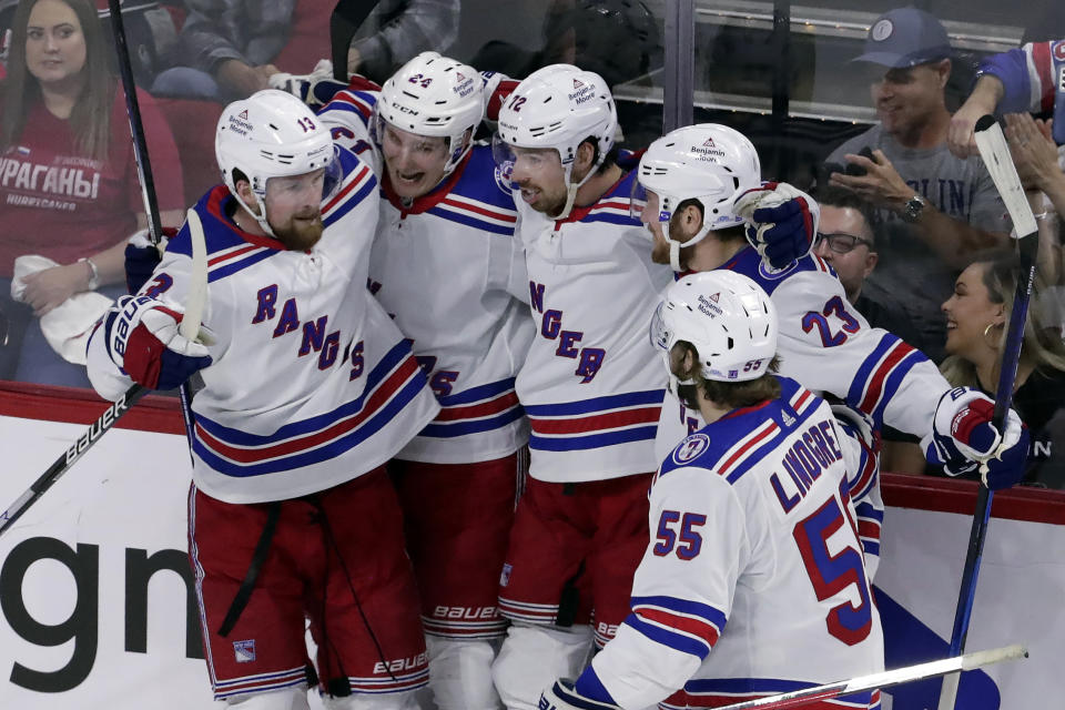 New York Rangers center Filip Chytil, center, celebrates his goal against the Carolina Hurricanes with left wing Alexis Lafrenière, left, right wing Kaapo Kakko, second from left, defenseman Adam Fox (23) and defenseman Ryan Lindgren (55) during the first period of Game 1 of an NHL hockey Stanley Cup second-round playoff series in Raleigh, N.C., Wednesday, May 18, 2022. (AP Photo/Chris Seward)