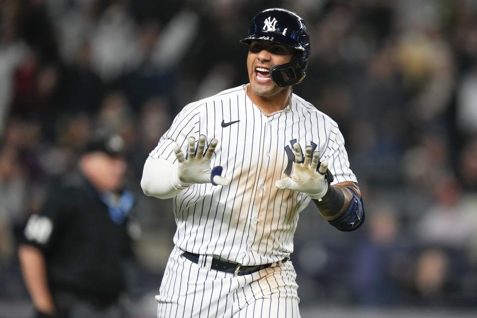 New York Yankees' Gleyber Torres gestures to teammates after hitting a home run during the third inning of a baseball game against the Philadelphia Phillies, Monday, April 3, 2023, in New York. (AP Photo/Frank Franklin II)