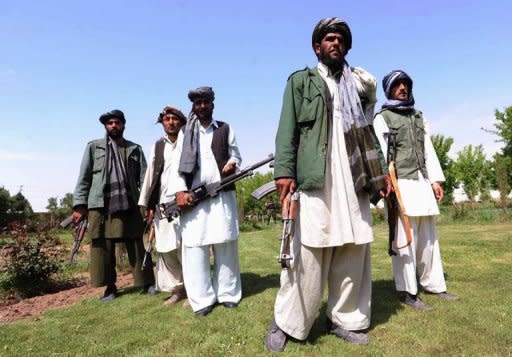 Former Taliban fighters join Afghan government forces during a ceremony in Herat province on April 26. Pakistan, Afghanistan and the United States agreed Friday to look at ways to provide safe passage to Afghan Taliban who are willing to join the peace process, officials said