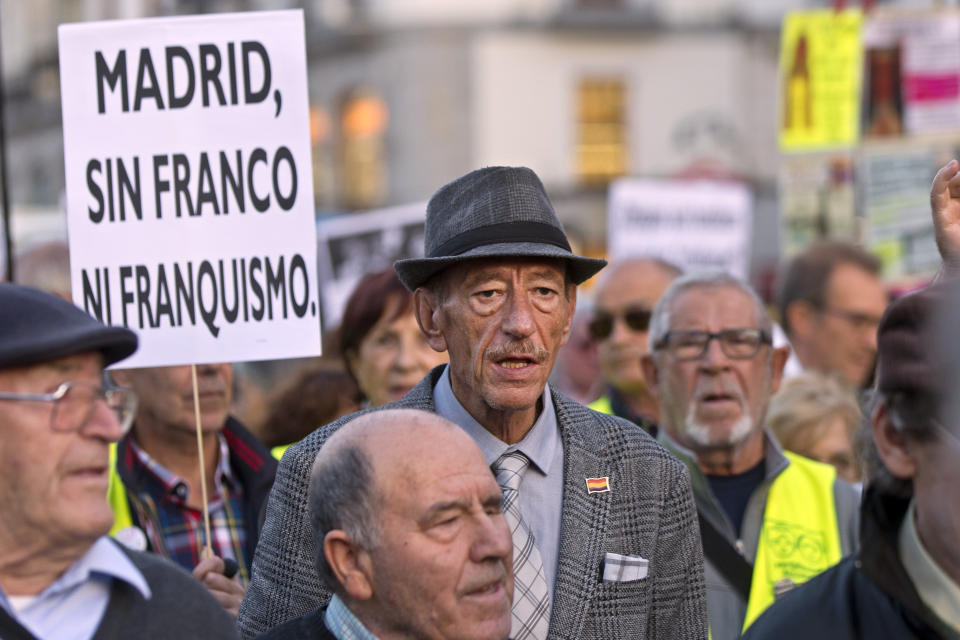 Protesters march in Madrid, Spain, Thursday Oct. 25, 2018. Hundreds of protesters in Madrid are urging government and Catholic church authorities to prevent the remains of the country’s 20th century dictator from ending in the city’s cathedral. Spain’s center-left government has promised to exhume this year Gen. Francisco Franco from a glorifying mausoleum, but the late dictator’s heirs have defied the plans by proposing for his remains to be relocated to a family crypt under the cathedral.Banner reads ' Madrid without Franco or Francoism'. (AP Photo/Paul White)