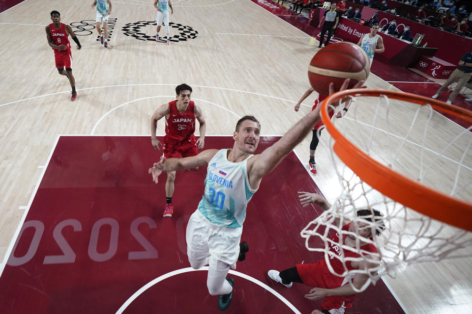 Slovenia's Zoran Dragic (30) drives to the basket against Japan's Kosuke Kanamaru (14) during a men's basketball game at the 2020 Summer Olympics, Thursday, July 29, 2021, in Saitama, Japan. (AP Photo/Eric Gay)