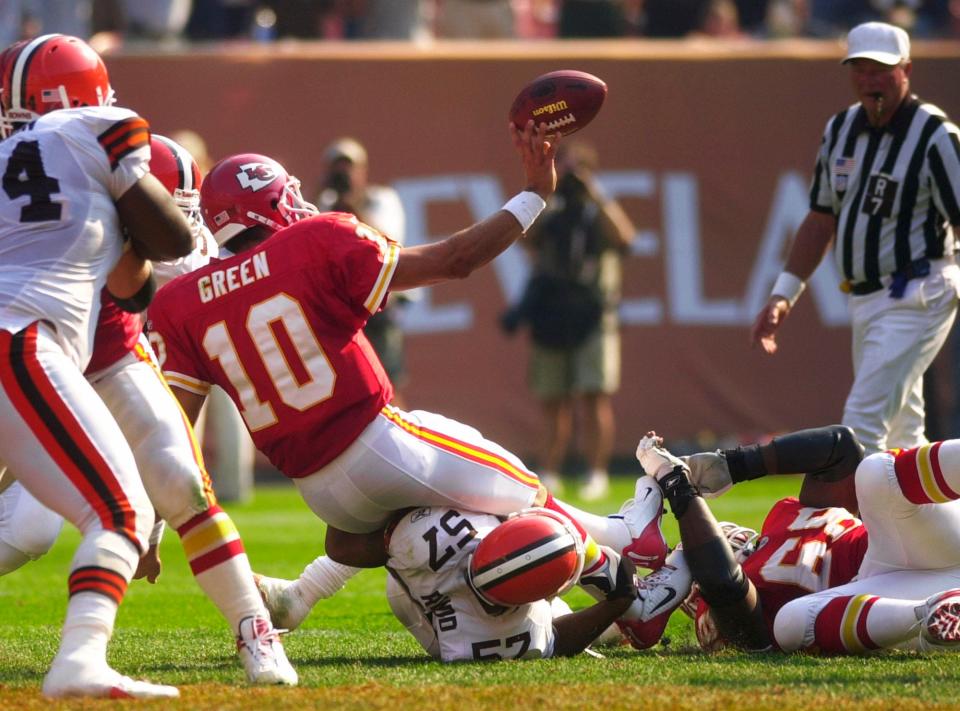 Chiefs quarterback Trent Green tosses the football to lineman John Tait as Green is tackled by Browns linebacker Dwayne Rudd as time expires on Sept. 8, 2002. Rudd was penalized for throwing his helmet, giving the Chiefs the chance to kick a game-winning field goal.