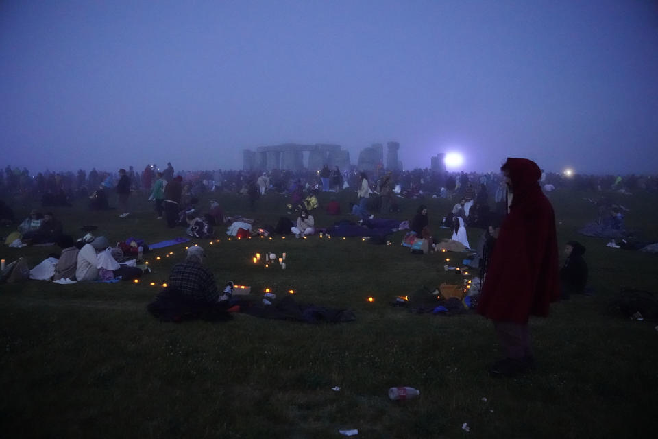 People gather during sunrise as they take part in the Summer Solstice at Stonehenge in Wiltshire, England Wednesday, June 21, 2023. (Andrew Matthews/PA via AP)