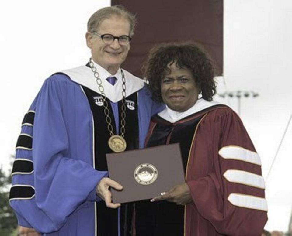 University of Puget Sound President Ronald Thomas awards an honorary doctorate to Tacoma Public Schools Superintendent Carla Santorno in 2016.