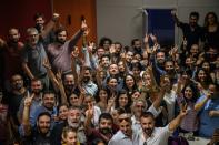 Employees of prominent pro-Kurdish television channel IMC TV flash the victory signs as Turkish police raided the channel's headquarters in Istanbul on October 4, 2016