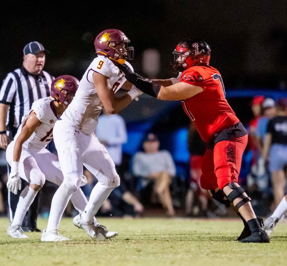 Salpointe Catholic defensive end Elijah Rushing (9) is blocked by Liberty tackle Kaden Haeckel (77) on Oct. 13.