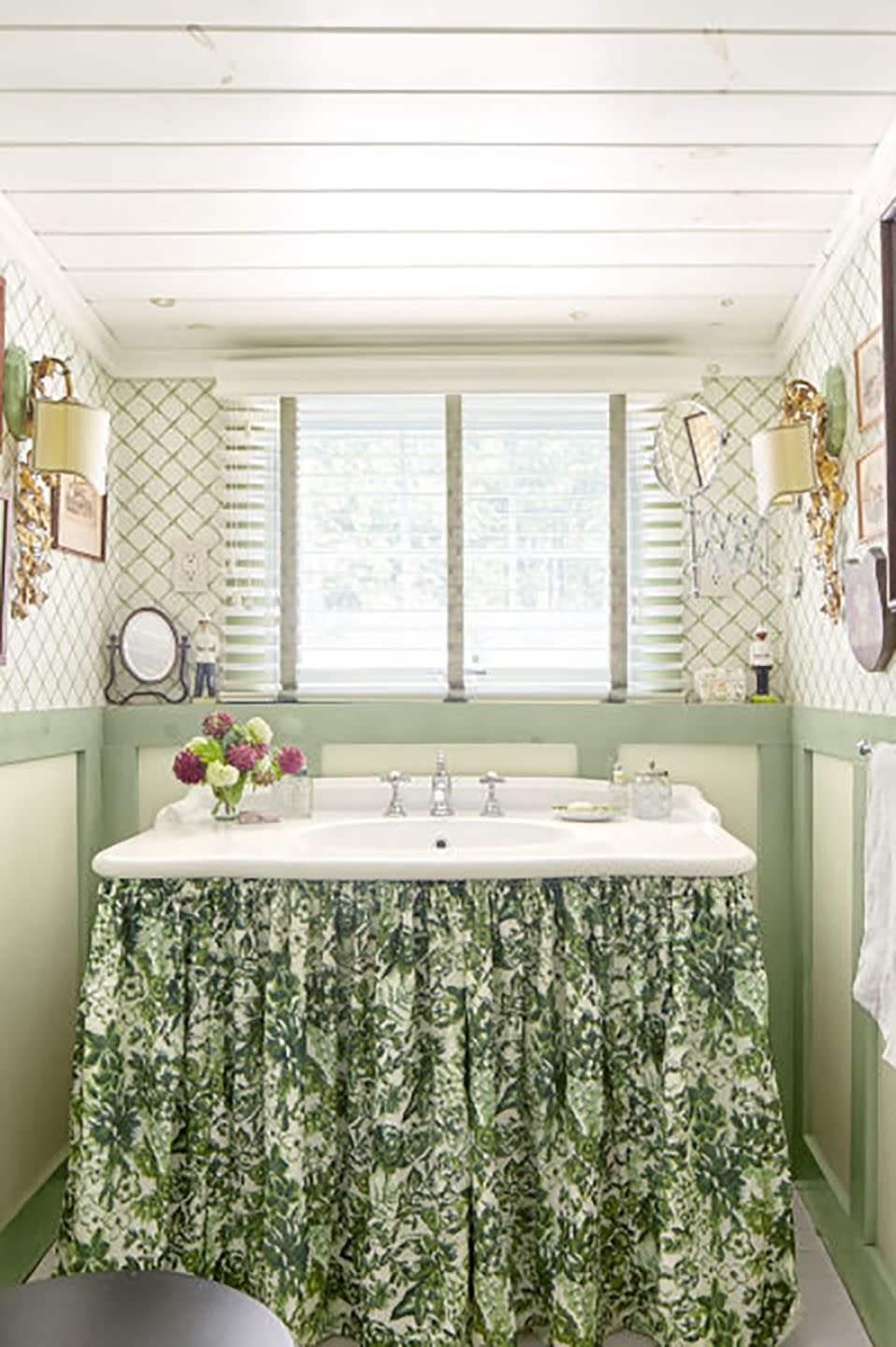 green powder room with lattice wallpaper