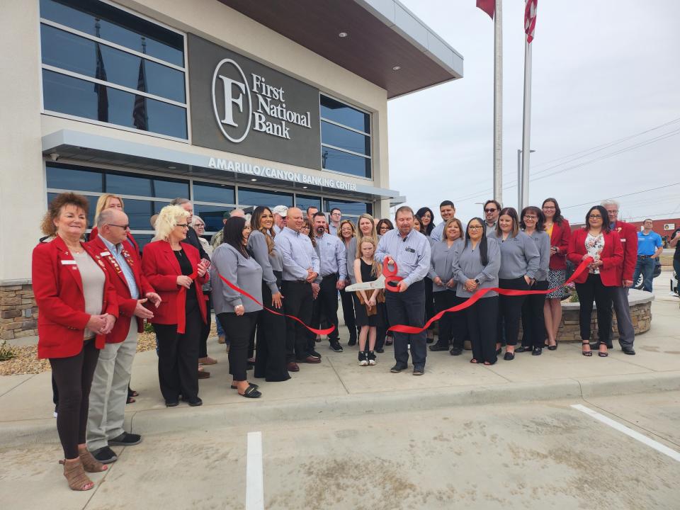 The Amarillo Chamber of Commerce commemorates the grand opening of the First National Bank Amarillo/Canyon location Thursday afternoon with ribbon cutting.