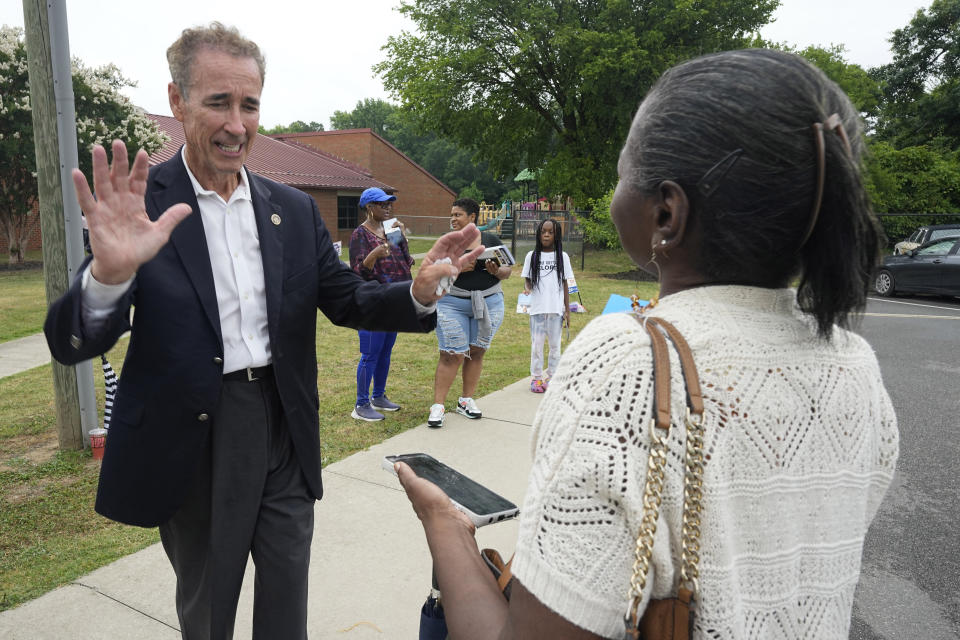 Virginia State Sen. Joe Morrissey, left, greets a voter as he visits a polling precinct Tuesday, June 20, 2023, in Henrico, Va. Morrissey is facing former Delegate Lashrecse Aird in a Democratic primary for a newly redrawn Senate district. (AP Photo/Steve Helber)