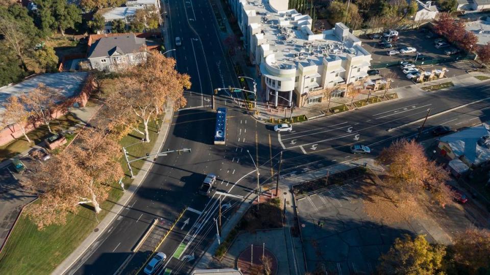 Vehicles drive through the intersection of Broadway and Martin Luther King Jr. Boulevard in Sacramento’s Oak Park neighborhood last month. Traffic calming measures have been installed at the intersection, which has long history of crashes. The St. Hope administration building, center top, has been hit by several vehicles.