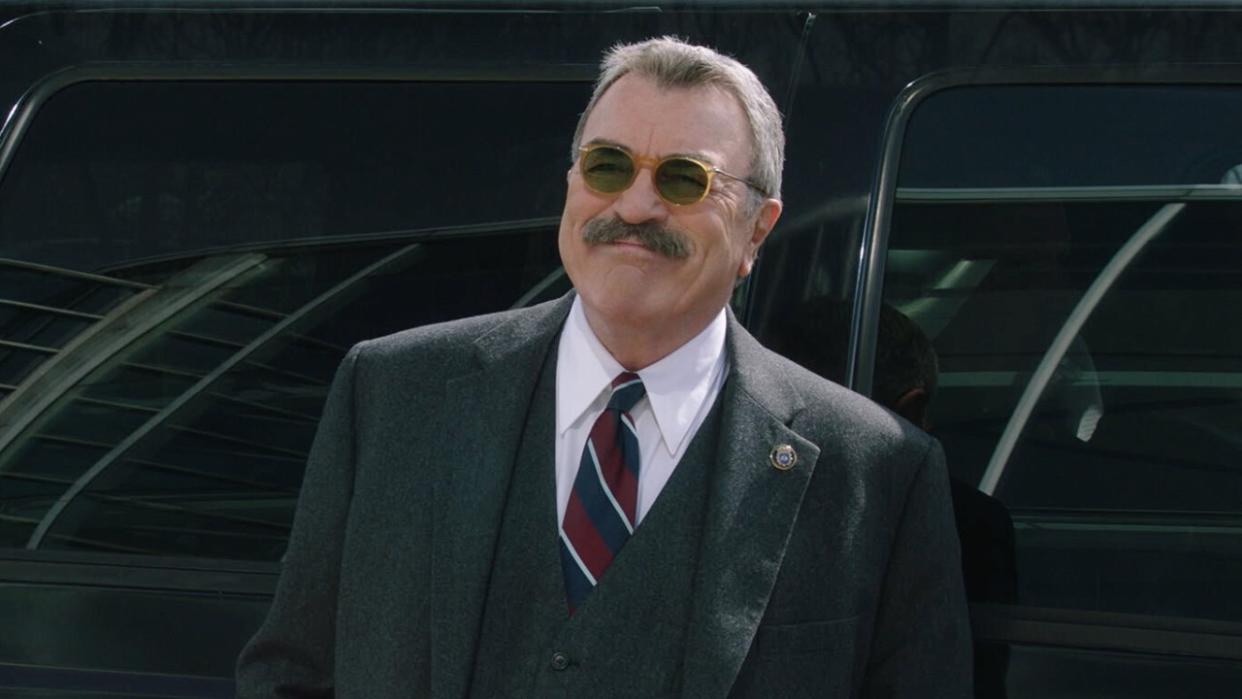  Frank Reagan in sunglasses outside smiling in Blue Bloods Season 13. 
