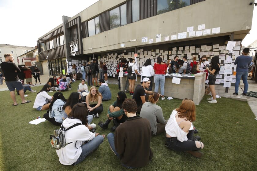 LOS ANGELES, CA - OCTOBER 22: USC students gather Friday afternoon at the Sigma Nu fraternity house near the USC campus. USC officials have placed the Sigma Nu fraternity chapter on interim suspension following allegations that women were drugged and sexually assaulted at the fraternity house. In a crime alert issued Thursday, the USC Department of Public Safety said campus officials received "a report of sexual assault" at the Sigma Nu fraternity house locate at 660 W. 28th St. "The university also has received reports of drugs being placed into drinks during a party at the same fraternity house, leading to possible drug-facilitated sexual assaults," according to the alert. USC on Friday, Oct. 22, 2021 in Los Angeles, CA. (Al Seib / Los Angeles Times).