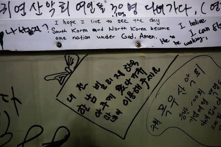 A pro-unification message is seen on a wall in a small fisherman's restaurant on the island of Baengnyeong, which lies on the South Korean side of the Northern Limit Line (NLL), in the Yellow Sea in this April 11, 2014 file photograph. REUTERS/Damir Sagolj/Files