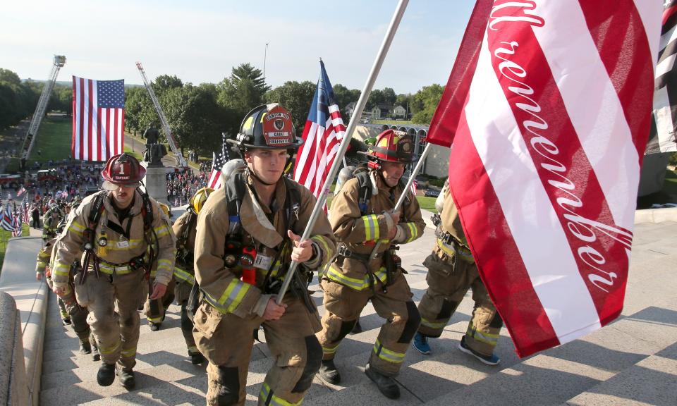 Firefighters participate in the Memorial Climb on the steps of the McKinley Presidential Library & Museum in Canton on Saturday. The event marked the 20th anniversary of the 9/11 attacks and recalled the memory of the 343 firefighters who lost their lives that day.