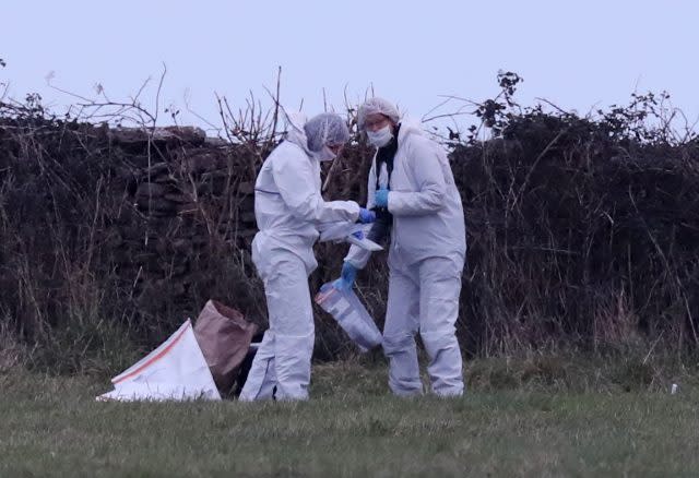 Forensic officers at work on a stretch of coastline near Swanage, close to where detectives have discovered items of women's clothing in a field