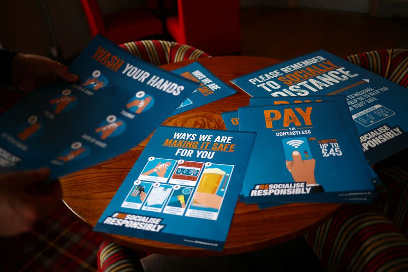 Safety signs are seen on a table in the Chandos Arms pub ahead of pubs reopening following the coronavirus disease (COVID-19) outbreak, in London