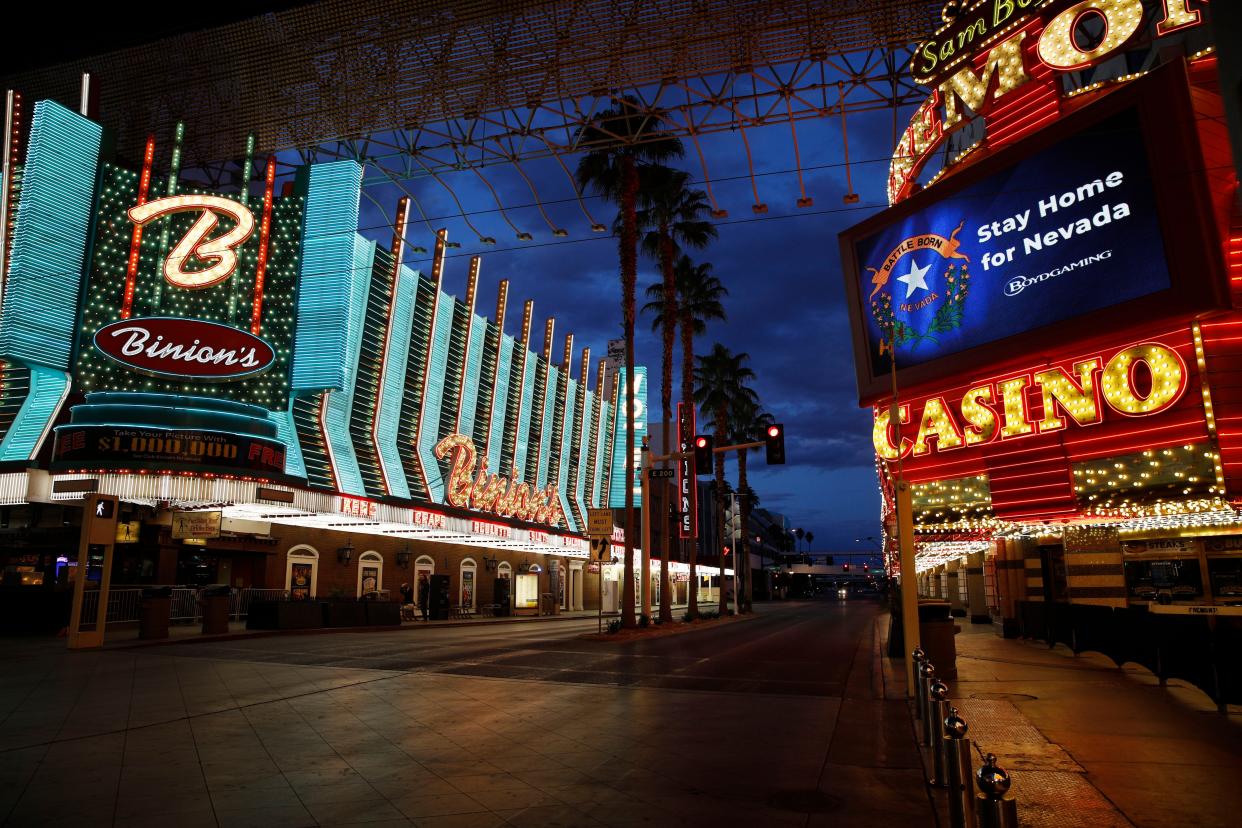 A sign indicates to "Stay Home for Nevada" along a usually busy Fremont Street after casinos were ordered to shut down due to the coronavirus outbreak Saturday, March 21, 2020, in Las Vegas.