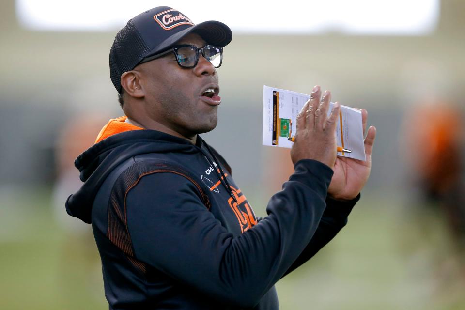 OSU defensive coordinator Derek Mason shouts instructions to his players on March 22.