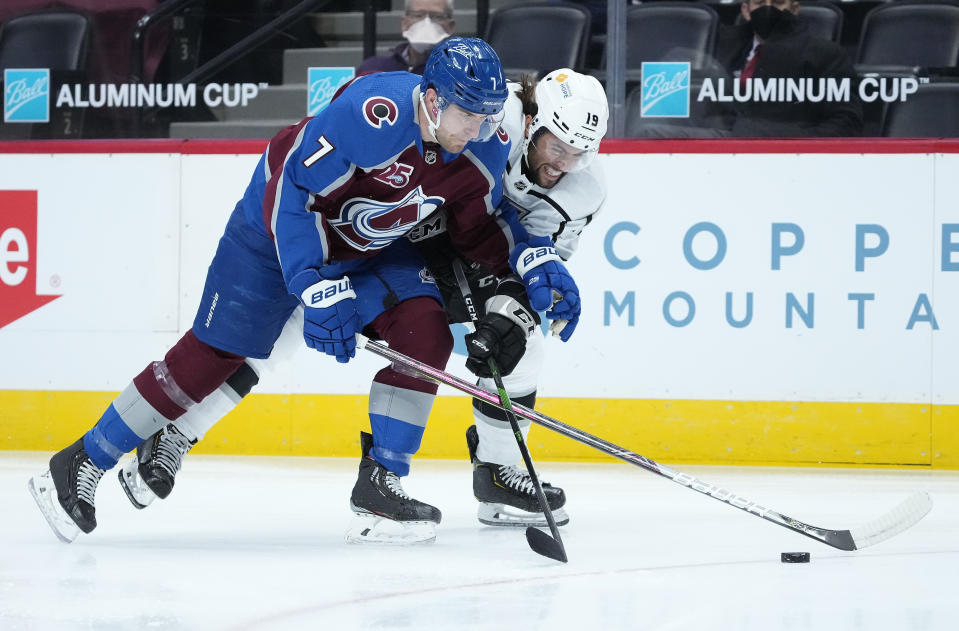 Colorado Avalanche defenseman Devon Toews (7) and Los Angeles Kings right wing Alex Iafallo (19) chase the puck during the first period of an NHL hockey game Wednesday, May, 12, 2021, in Denver. (AP Photo/Jack Dempsey)