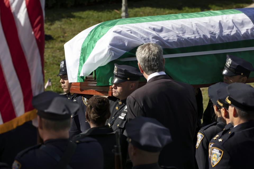 The casket bearing New York City police officer Brian Mulkeen is carried past New York Mayor Bill de Blasio into Church of the Sacred Heart, Friday, Oct. 4, 2019, in Monroe, N.Y. Authorities say Mulkeen was fatally hit Sunday by two police bullets while struggling with an armed man in the Bronx. He is the second New York City officer killed by friendly fire this year. (AP Photo/Mark Lennihan)