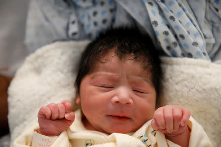 Newborn Alvin Reyes sleeps next to his mother Honduran migrant Erly Marcial, 21, at a hospital in Puebla, Mexico, November 13, 2018. REUTERS/Carlos Garcia Rawlins