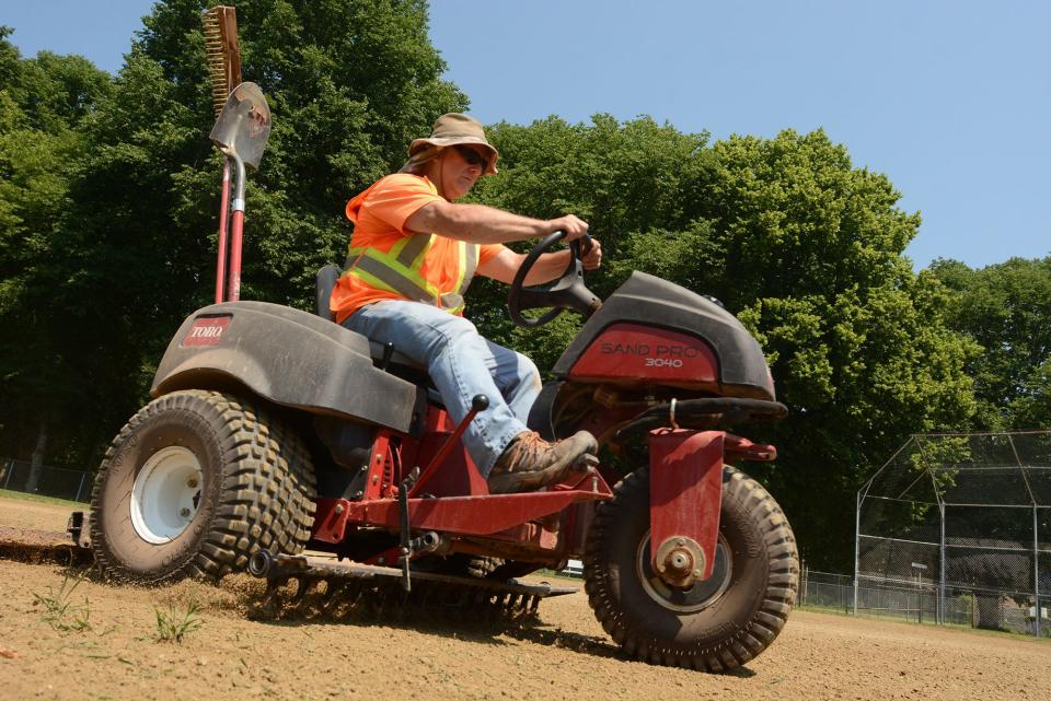 Loren Waggoner, of the Norwich Recreation Department, grooms a softball field at Luis DePina Recreation Fields last year in 90 degree weather.