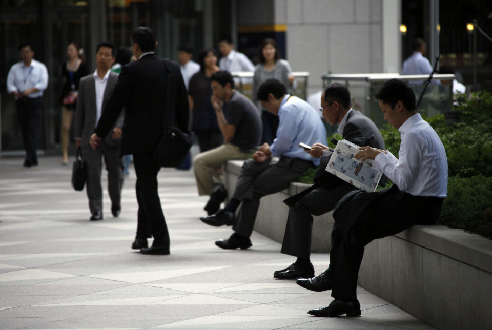 In this June 29, 2012 photo, Japanese office workers rest at a business district in Tokyo. Government data showed Tuesday, July 31, Japan's unemployment rate for June improved slightly to 4.3 percent, declining for the second straight month, but the nation continues to struggle after last year's disaster. The Ministry of Internal Affairs and Communications reported that the jobless rate last month fell 0.1 percentage point from 4.4 percent in May. (AP Photo/Koji Sasahara)