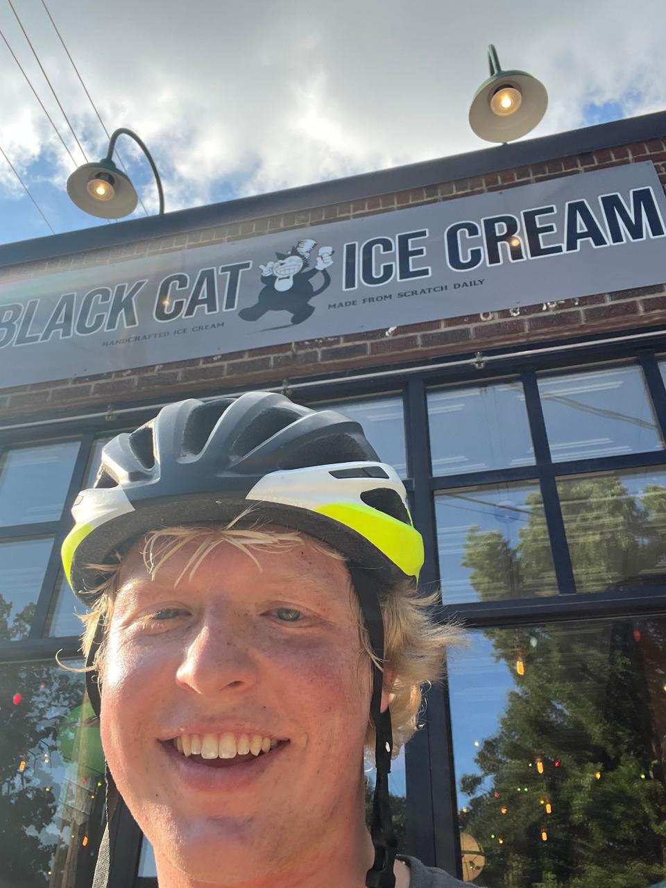 James Douthit takes a selfie in front of Black Cat Ice Cream in Des Moines.