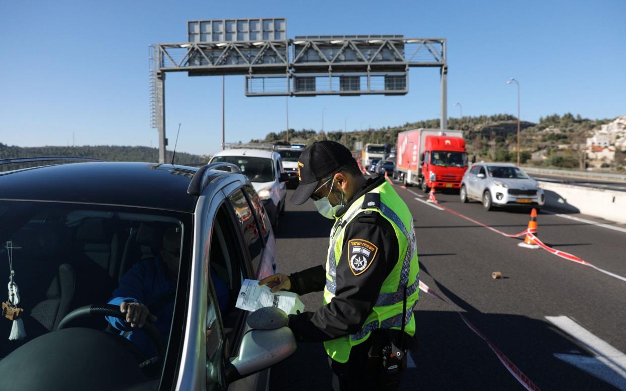 Police stop vehicles at a roadblock to enforce a lockdown in Jerusalem on January 8 - ABIR SULTAN/EPA-EFE/Shutterstock 
