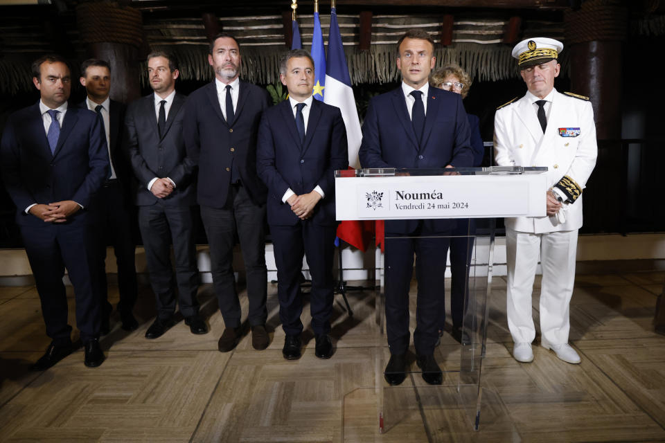 French President Emmanuel Macron, second right, delivers a speech at New Caledonia's High Commissioner residency, in Noumea, France's Pacific territory of New Caledonia Thursday May, 23, 2024. French President Emmanuel Macron pushed Thursday on a visit to riot-hit New Caledonia for the removal of protesters' barricades and said police sent in to help battle deadly unrest in the French Pacific archipelago "will stay as long as necessary," even as security services back in France focus in coming weeks on safeguarding the Paris Olympics. (Ludovic Marin, Pool via AP)