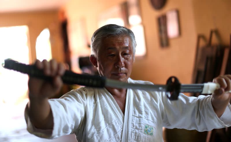 Samurai Suemitsu shows a katana sword at his home in Curitiba