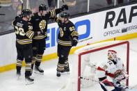 Boston Bruins' Charlie Coyle (13) celebrates his goal past Florida Panthers' Sergei Bobrovsky (72) with teammates Morgan Geekie (39) and Brad Marchand (63) during the second period of an NHL hockey game, Saturday, April 6, 2024, in Boston. (AP Photo/Michael Dwyer)