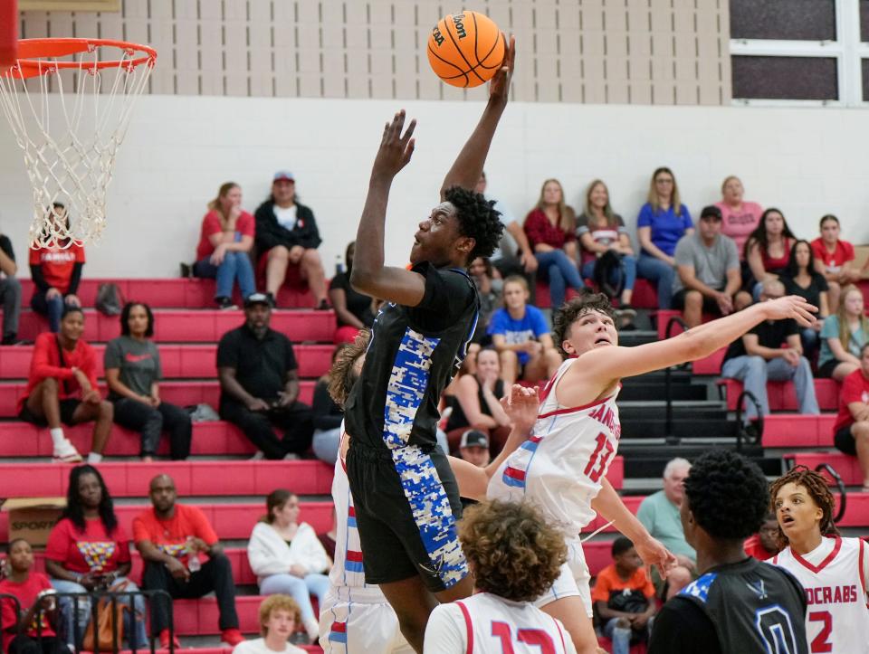 Matanzas' Henry Robinson Jr. (5) goes for a dunk during a game with Seabreeze at Seabreeze High School, Friday, Dec. 1, 2023.