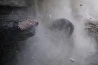 Goran Tomasevic, a Serbian photographer working for Reuters, won the 1st Prize Spot News Stories category of the 2014 World Press Photo contest with his series of pictures which includes this one of Syrian rebel fighters taking cover amid flying debris and shrapnel after being hit by a tank shell in the Ain Tarma neighborhood of Damascus, taken January 13, 2013. REUTERS/Goran Tomasevic (SYRIA - Tags: MEDIA SOCIETY TPX IMAGES OF THE DAY)