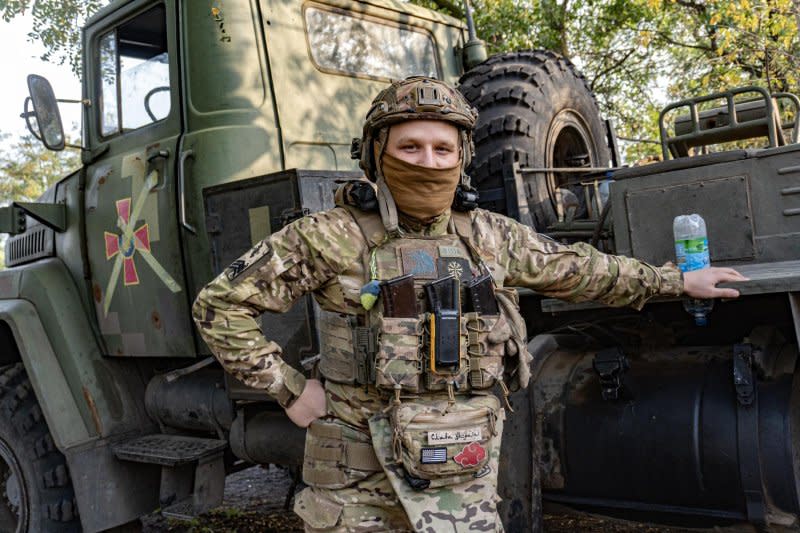 A Ukrainian soldier nicknamed "Barber" stands next to the BM-21 multiple launch rocket system he operates. Photo by Dylan Burns/UPI