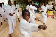Demba, 8, a Koranic student, called a talibe, attends karate training in the courtyard of Maison de la Gare, an organisation that helps talibe street children reintegrate into society, in Saint-Louis, Senegal, February 8, 2019. REUTERS/Zohra Bensemra