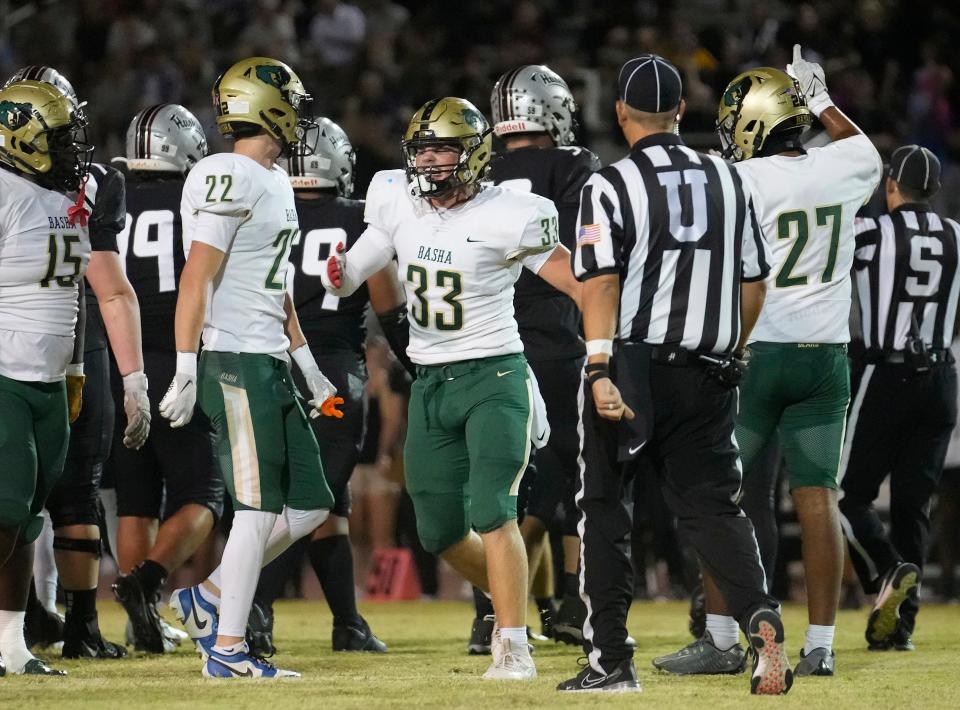 Basha linebacker Jack Bleier (33) celebrates a tackle against Hamilton during a game at Hamilton High School in Chandler on Oct. 6, 2023.
