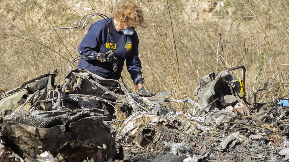 An investigator, pictured here working at the scene of the helicopter crash that killed Kobe Bryant.