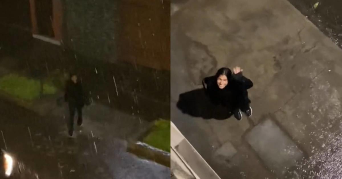 A woman walks in the middle of the rain to see her boyfriend