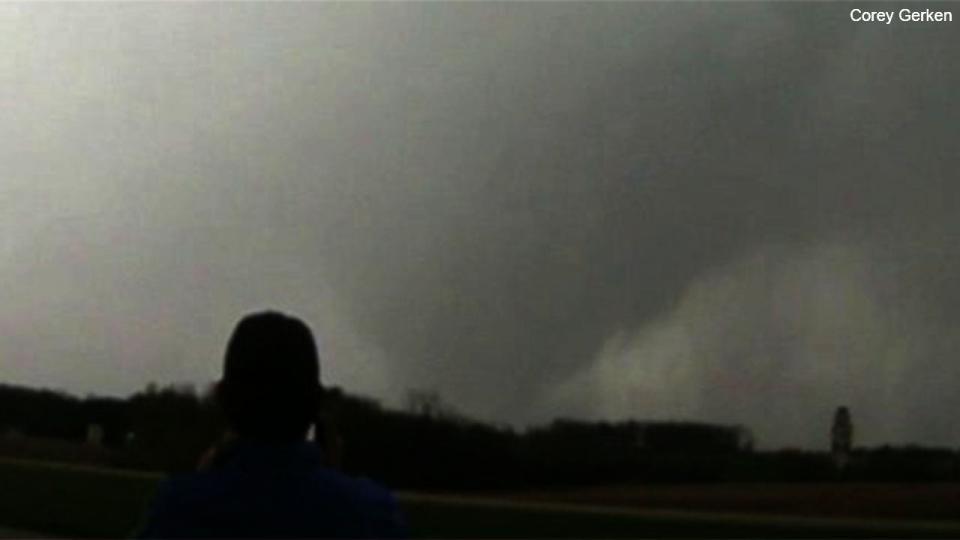 Storm chasers watch a tornado spin near West Point, Iowa, on April 16, 2024.