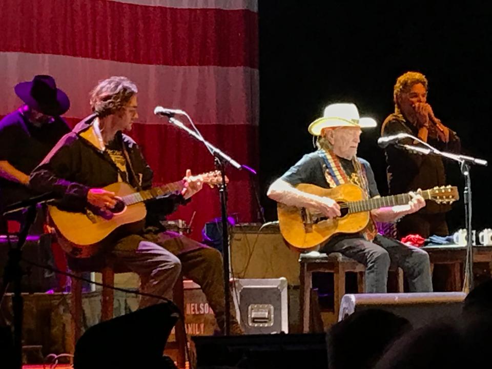 Willie Nelson and his band, including son Micah (seated left) at Outlaw Music Festival at The Pavilion at Star Lake.
